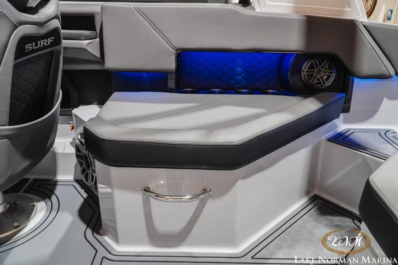 Slide: The Image of 2026 Cobalt R4 Surf boat interior with sleek seating and blue LED lighting. - 24
