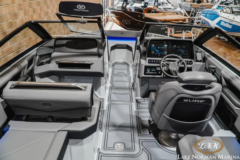 Slide: The Image of Interior of 2026 Cobalt R4 Surf boat with modern dashboard and seating at Lake Norman Marina. - 12