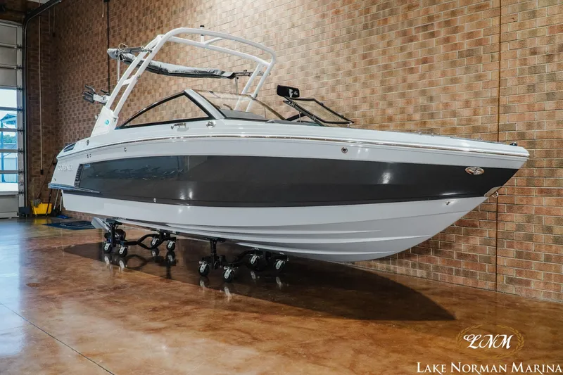 Slide: The Image of 2026 Cobalt R4 Surf boat displayed indoors at Lake Norman Marina. - 3
