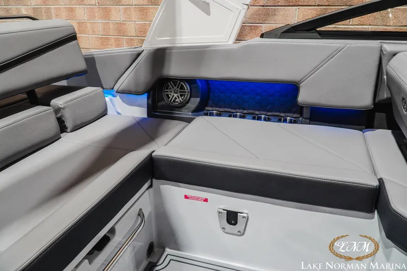 Slide: The Image of 2026 Cobalt R4 Surf boat interior with gray seating and blue LED lighting. - 23