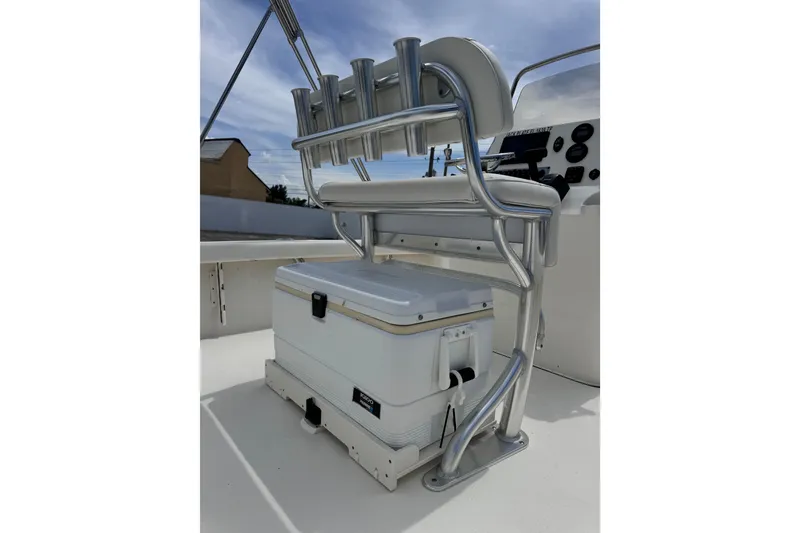 Slide: The Image of 2023 Key West 230 Bay Reef boat interior with cooler and seating. - 12