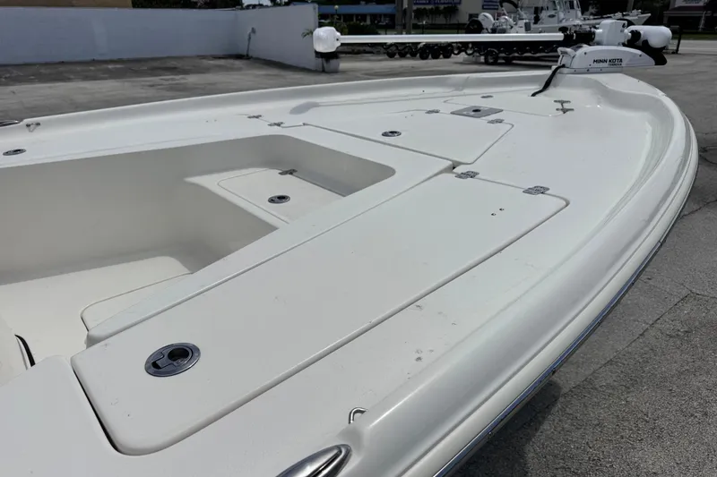 Slide: The Image of 2023 Key West 230 Bay Reef boat deck with storage compartments and Minn Kota trolling motor. - 7