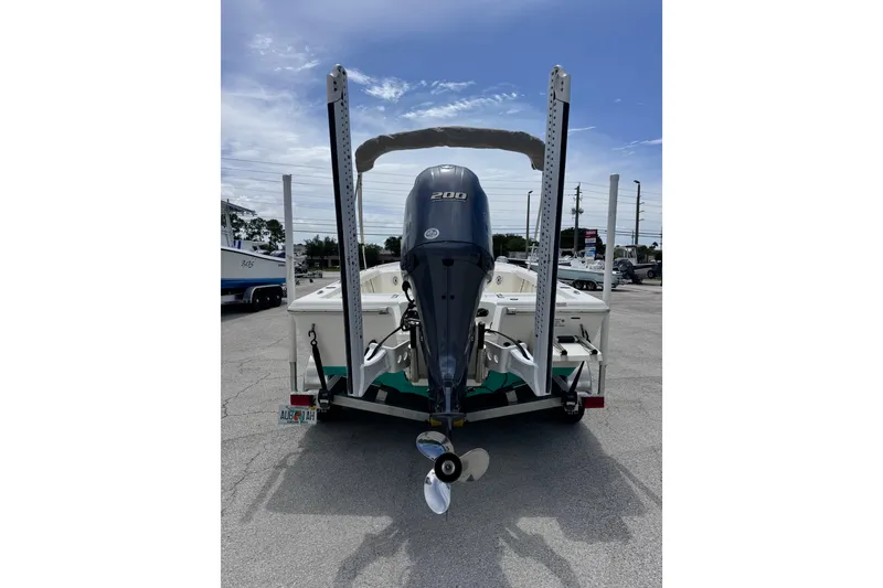 Slide: The Image of 2023 Key West 230 Bay Reef boat with powerful outboard motor on trailer. - 3