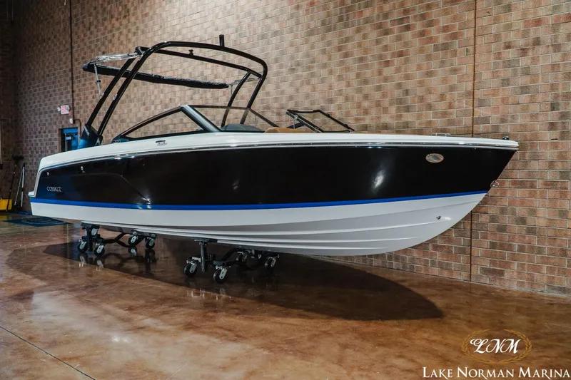 Slide: The Image of 2026 Cobalt CS23 boat displayed indoors at Lake Norman Marina. - 3