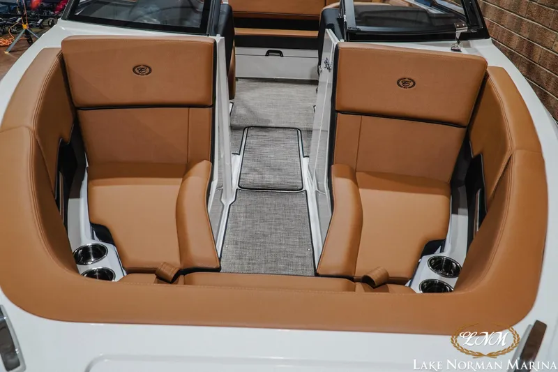 Slide: The Image of Luxurious interior of 2026 Cobalt CS23 boat with tan seating and cup holders. - 5