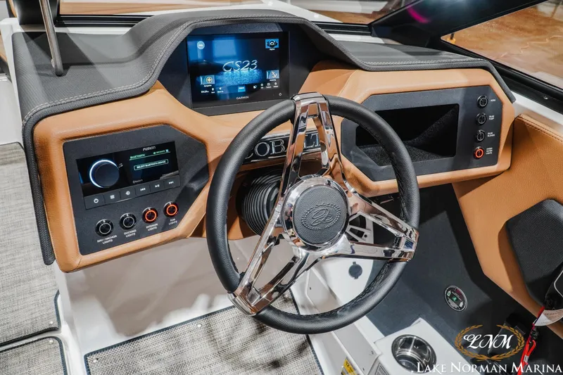 Slide: The Image of 2026 Cobalt CS23 boat dashboard with modern controls and sleek steering wheel design. - 12