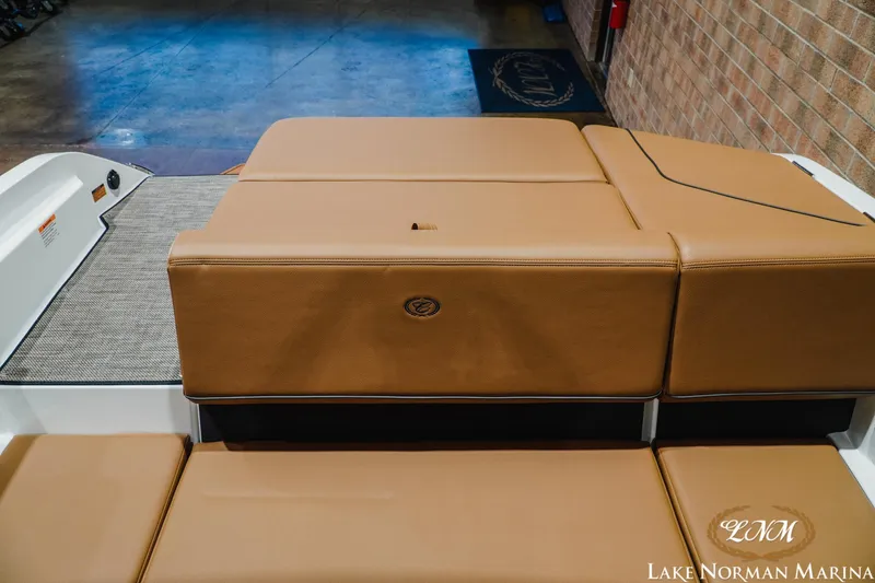 Slide: The Image of 2026 Cobalt CS23 boat interior with tan leather seating at Lake Norman Marina. - 19
