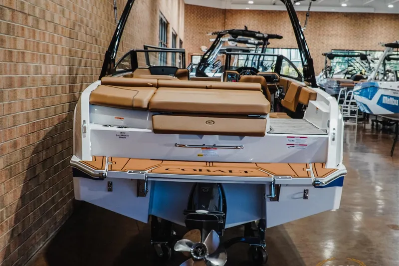 Slide: The Image of 2026 Cobalt CS23 boat in showroom, featuring tan seating and sleek design. - 7
