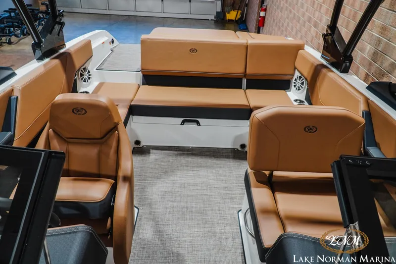Slide: The Image of 2026 Cobalt CS23 boat interior with tan leather seating and modern design at Lake Norman Marina. - 15
