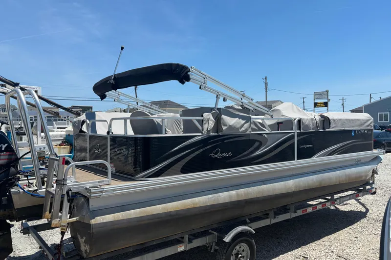 Slide: The Image of 2017 Qwest LS 822 Bar pontoon boat on trailer, covered and parked outdoors. - 3