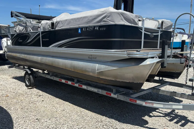 Slide: The Image of Pontoon boat Qwest LS 822 Bar 2017 on trailer, covered and parked outdoors. - 4