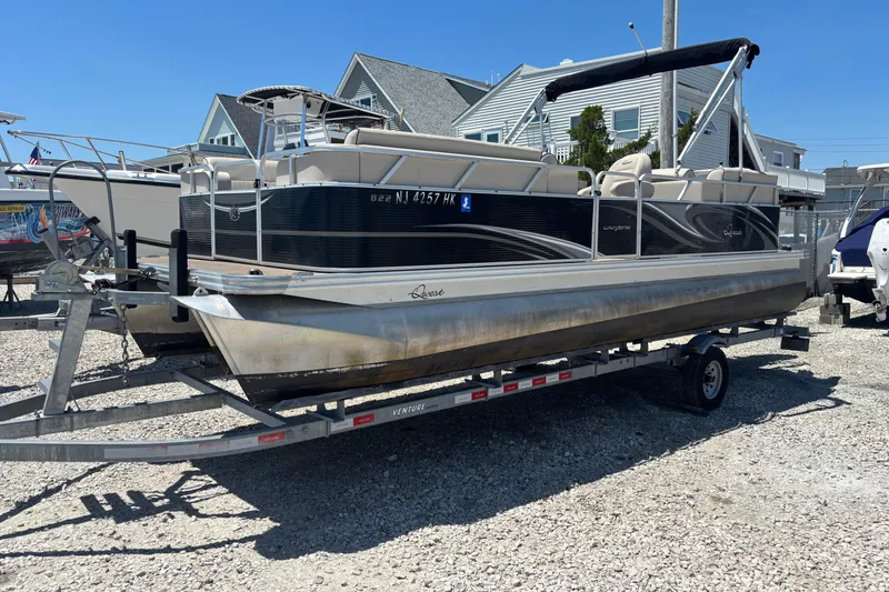 Slide: The Image of 2017 Qwest LS 822 Bar pontoon boat on trailer, parked outdoors. - 2