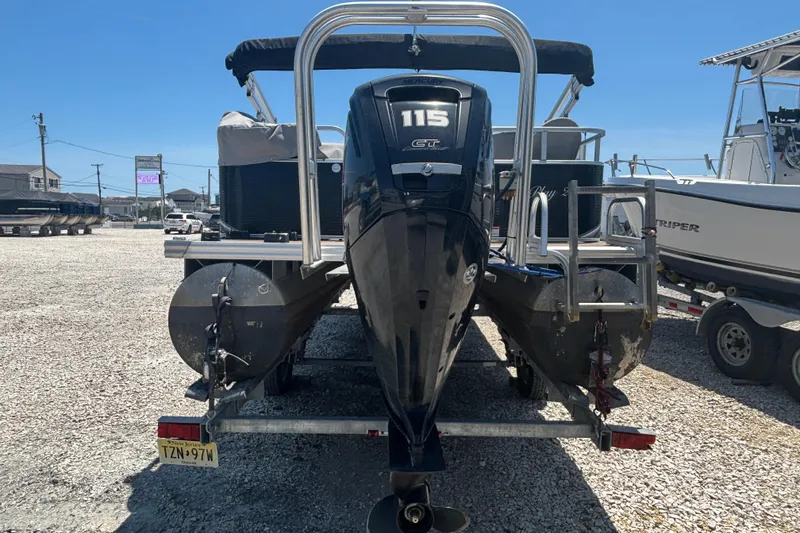 Slide: The Image of 2017 Qwest LS 822 Bar pontoon boat with Mercury 115 GT engine, parked on gravel. - 5