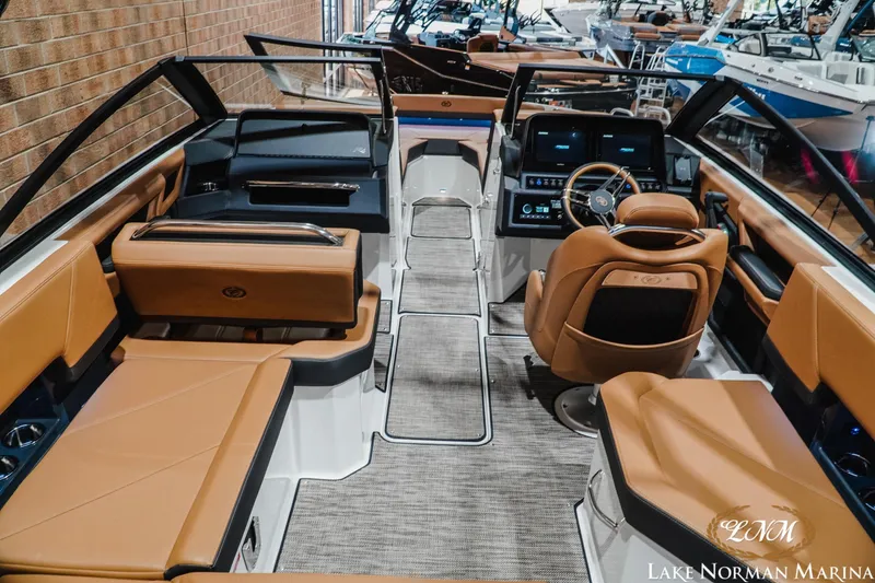 Slide: The Image of 2026 Cobalt R4 boat interior with luxurious tan seating and modern dashboard at Lake Norman Marina. - 12