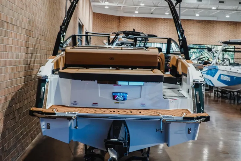 Slide: The Image of 2026 Cobalt R4 boat displayed indoors, showcasing rear seating and swim platform. - 9
