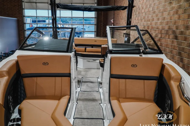 Slide: The Image of 2026 Cobalt R4 boat interior with tan seating and glass windshields at Lake Norman Marina. - 7