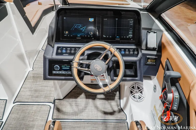 Slide: The Image of 2026 Cobalt R4 boat dashboard with modern controls and sleek steering wheel design. - 16