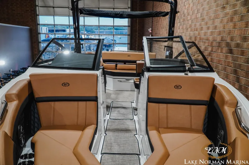 Slide: The Image of Interior view of a 2026 Cobalt R4 boat with tan seating at Lake Norman Marina. - 6
