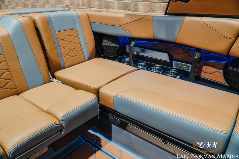 Slide: The Image of Luxurious interior seating of 2026 Malibu Wakesetter 23 LSV boat with tan and gray upholstery. - 22