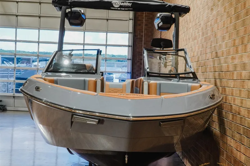 Slide: The Image of 2026 Malibu Wakesetter 23 LSV boat in showroom, featuring sleek design and luxury seating. - 4
