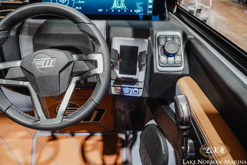 Slide: The Image of 2026 Malibu Wakesetter 23 LSV dashboard with steering wheel and control panel. - 17