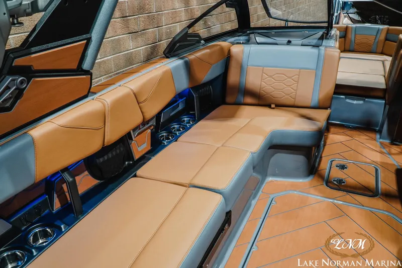 Slide: The Image of 2026 Malibu Wakesetter 23 LSV interior with luxurious tan and gray seating. - 11