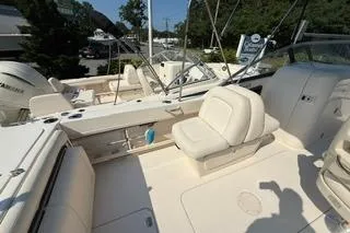 Slide: The Image of 2015 Grady-White Freedom 225 boat interior with seating and console, docked outdoors. - 5