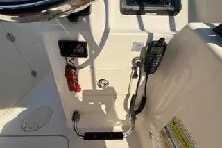 Slide: The Image of 2015 Grady-White Freedom 225 boat dashboard with radio and controls. - 10