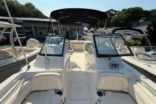 Slide: The Image of 2015 Grady-White Freedom 225 boat with dual consoles and seating, docked outdoors. - 16