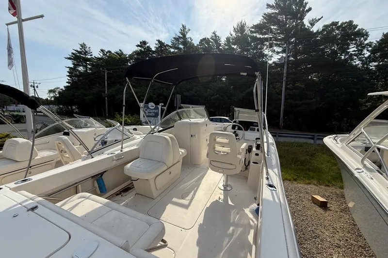 Slide: The Image of 2015 Grady-White Freedom 225 boat with seating and canopy, parked outdoors. - 3