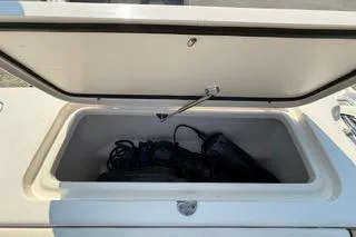 Slide: The Image of Open storage compartment on a 2015 Grady-White Freedom 225 boat. - 21