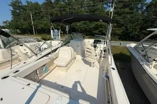 Slide: The Image of 2015 Grady-White Freedom 225 boat with seating and canopy, docked outdoors. - 4