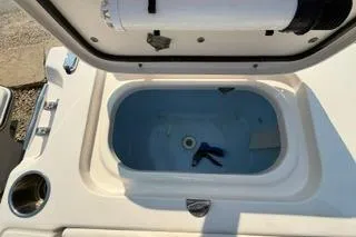 Slide: The Image of 2015 Grady-White Freedom 225 boat livewell with open lid and cup holder. - 22