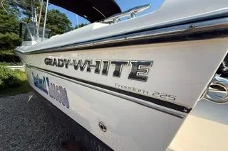 Slide: The Image of 2015 Grady-White Freedom 225 boat side view with logo and model name. - 34