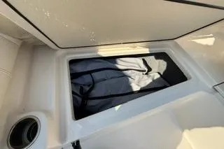 Slide: The Image of Storage compartment on a 2015 Grady-White Freedom 225 boat, featuring a sleek design. - 31