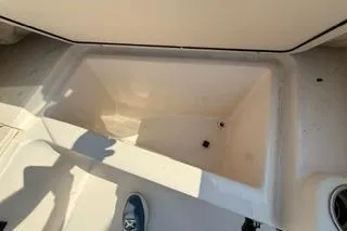 Slide: The Image of 2015 Grady-White Freedom 225 boat storage compartment, open and empty. - 30