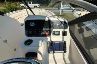 Slide: The Image of 2015 Grady-White Freedom 225 boat dashboard with steering wheel and control panel. - 9