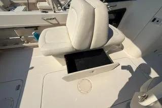 Slide: The Image of 2015 Grady-White Freedom 225 boat seat with open storage compartment. - 26