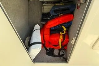 Slide: The Image of Storage compartment with life jackets on a 2015 Grady-White Freedom 225 boat. - 17