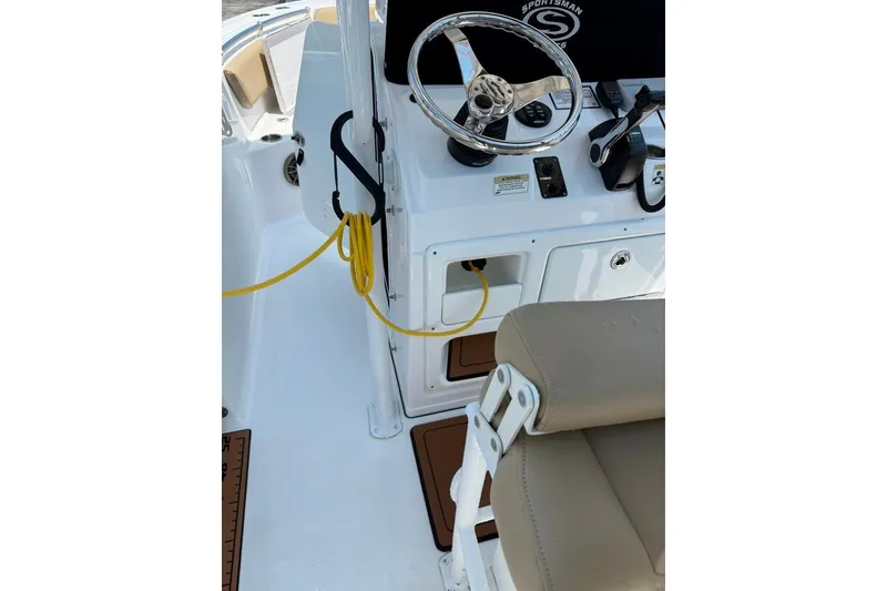 Slide: The Image of 2017 Sportsman Open 232 Center Console boat interior with steering wheel and seating. - 47