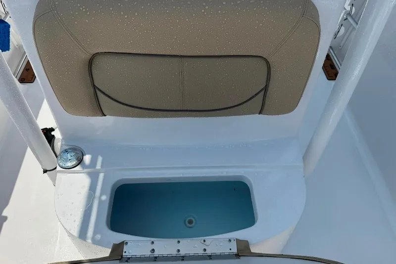 Slide: The Image of 2017 Sportsman Open 232 Center Console boat seat and storage compartment. - 22