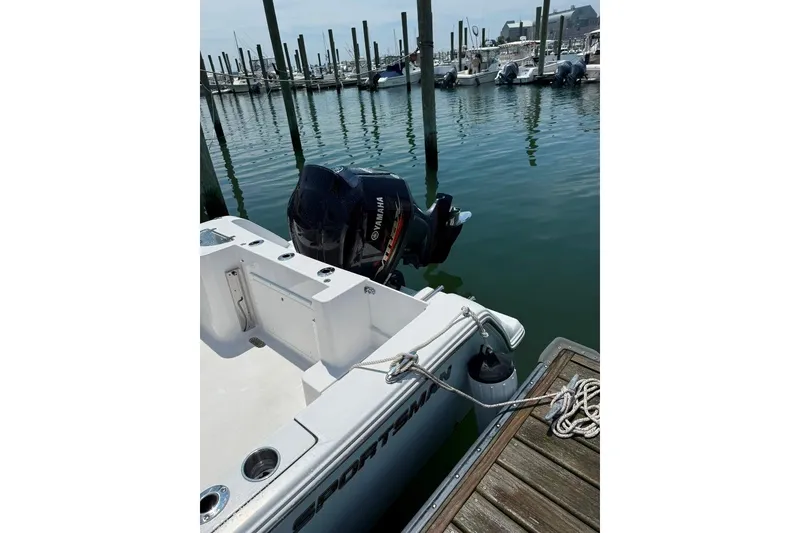Slide: The Image of 2017 Sportsman Open 232 Center Console boat docked with Yamaha outboard motor. - 6