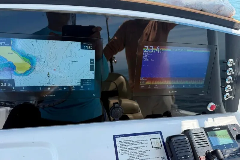 Slide: The Image of Dashboard of a 2017 Sportsman Open 232 Center Console with Garmin navigation displays. - 8