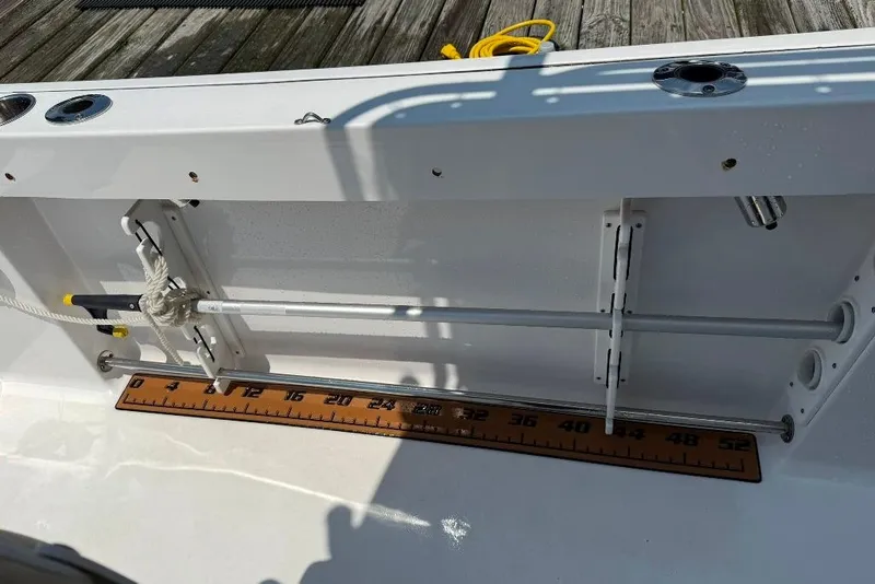 Slide: The Image of 2017 Sportsman Open 232 Center Console boat interior with measuring ruler and fishing rod holders. - 45