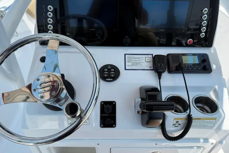 Slide: The Image of 2017 Sportsman Open 232 Center Console dashboard with steering wheel, controls, and navigation equipment. - 7