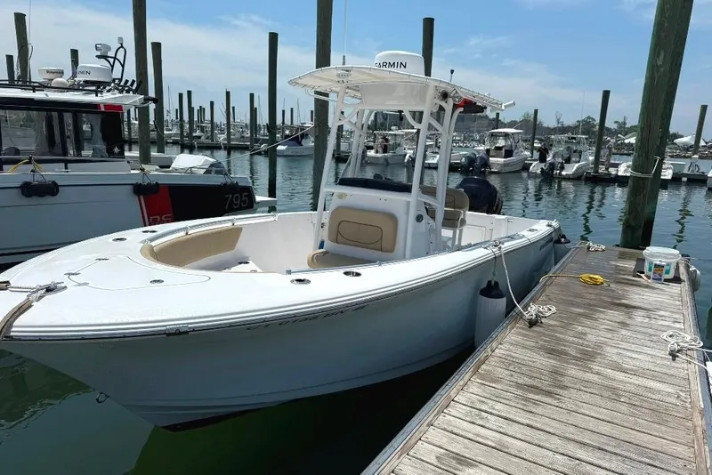 Slide: The Image of 2017 Sportsman Open 232 Center Console boat docked at marina. - 2
