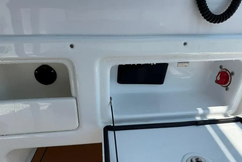 Slide: The Image of 2017 Sportsman Open 232 Center Console dashboard with controls and storage compartments. - 28