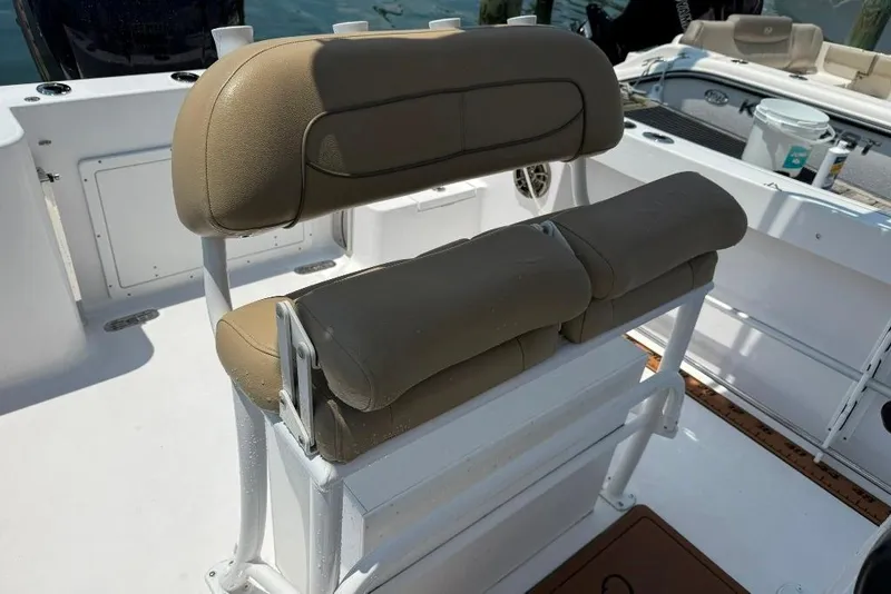 Slide: The Image of 2017 Sportsman Open 232 Center Console boat seating area with tan cushions. - 31