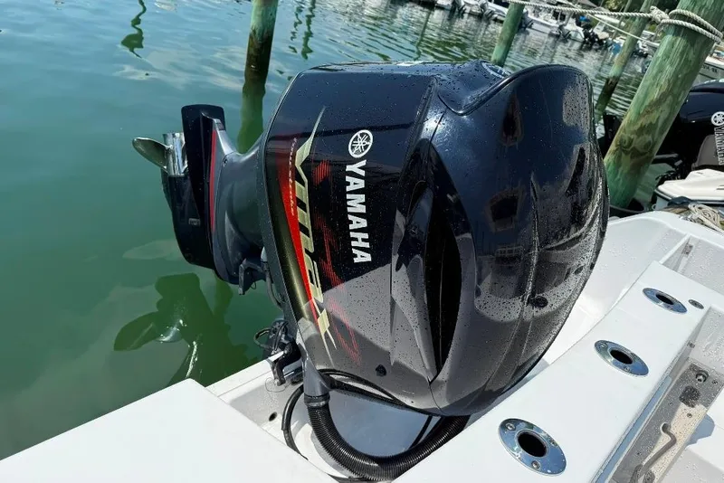 Slide: The Image of 2017 Sportsman Open 232 Center Console with Yamaha outboard motor in marina. - 13