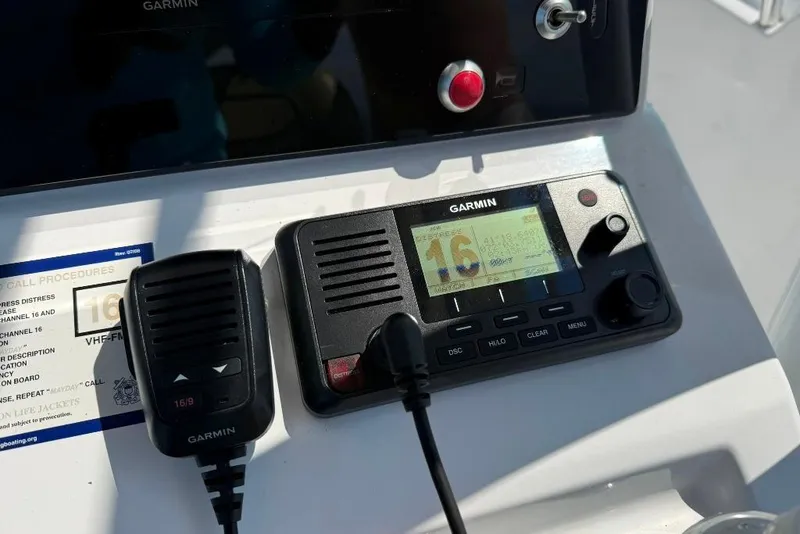 Slide: The Image of Garmin marine radio on 2017 Sportsman Open 232 Center Console boat dashboard. - 10